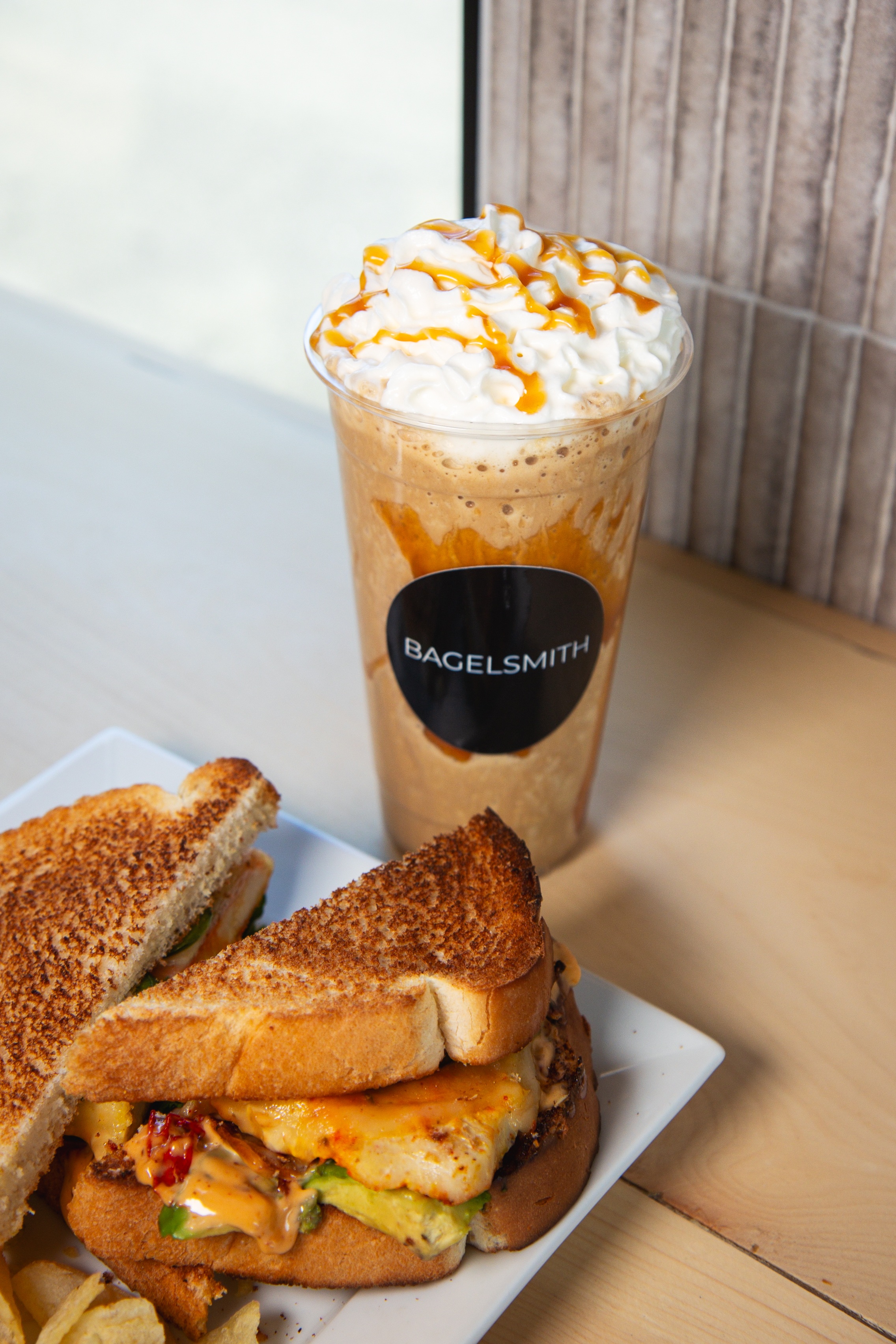 Caramel frappe with whipped cream and grilled chicken sandwich
