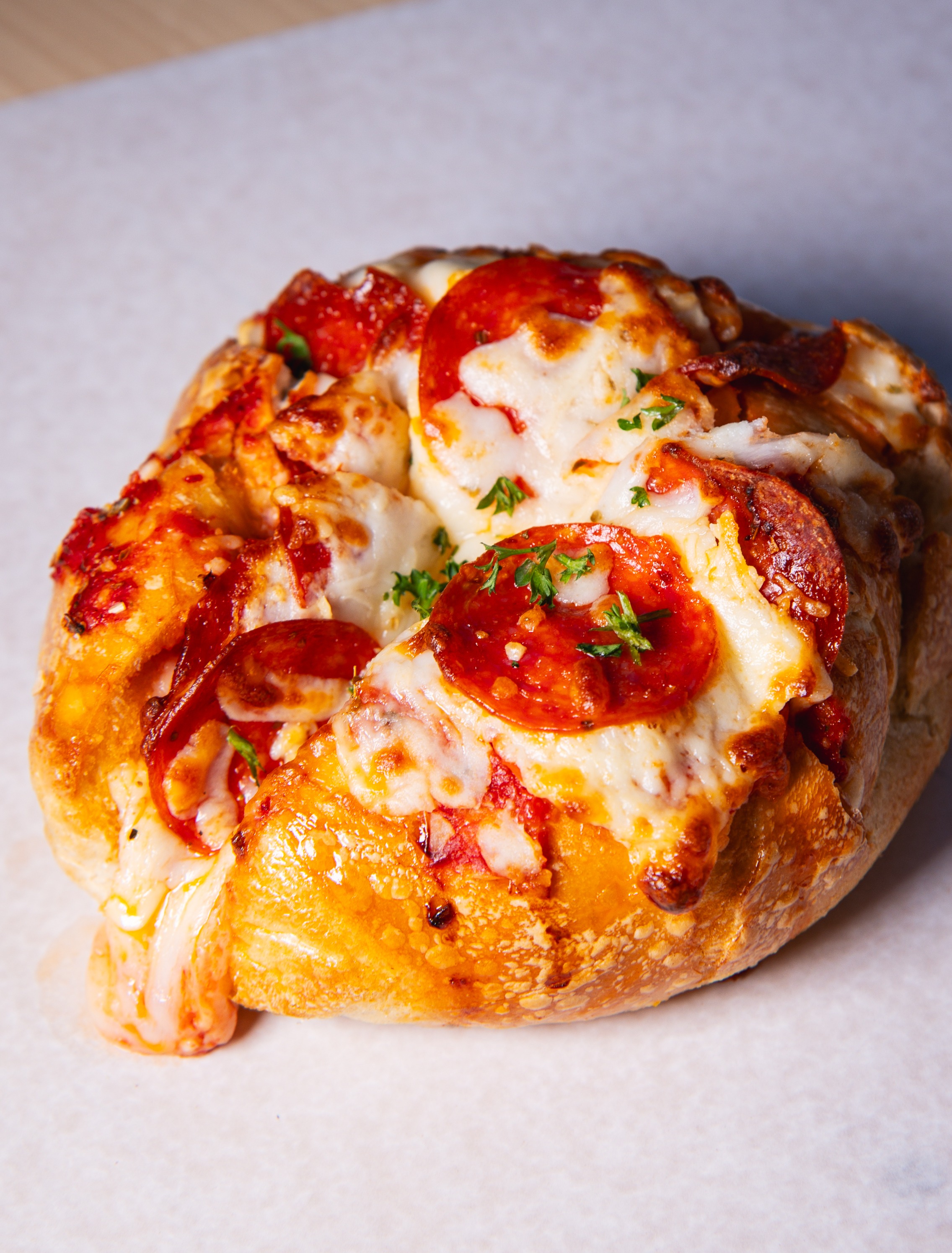 Pepperoni pizza bagel with melted cheese and parsley